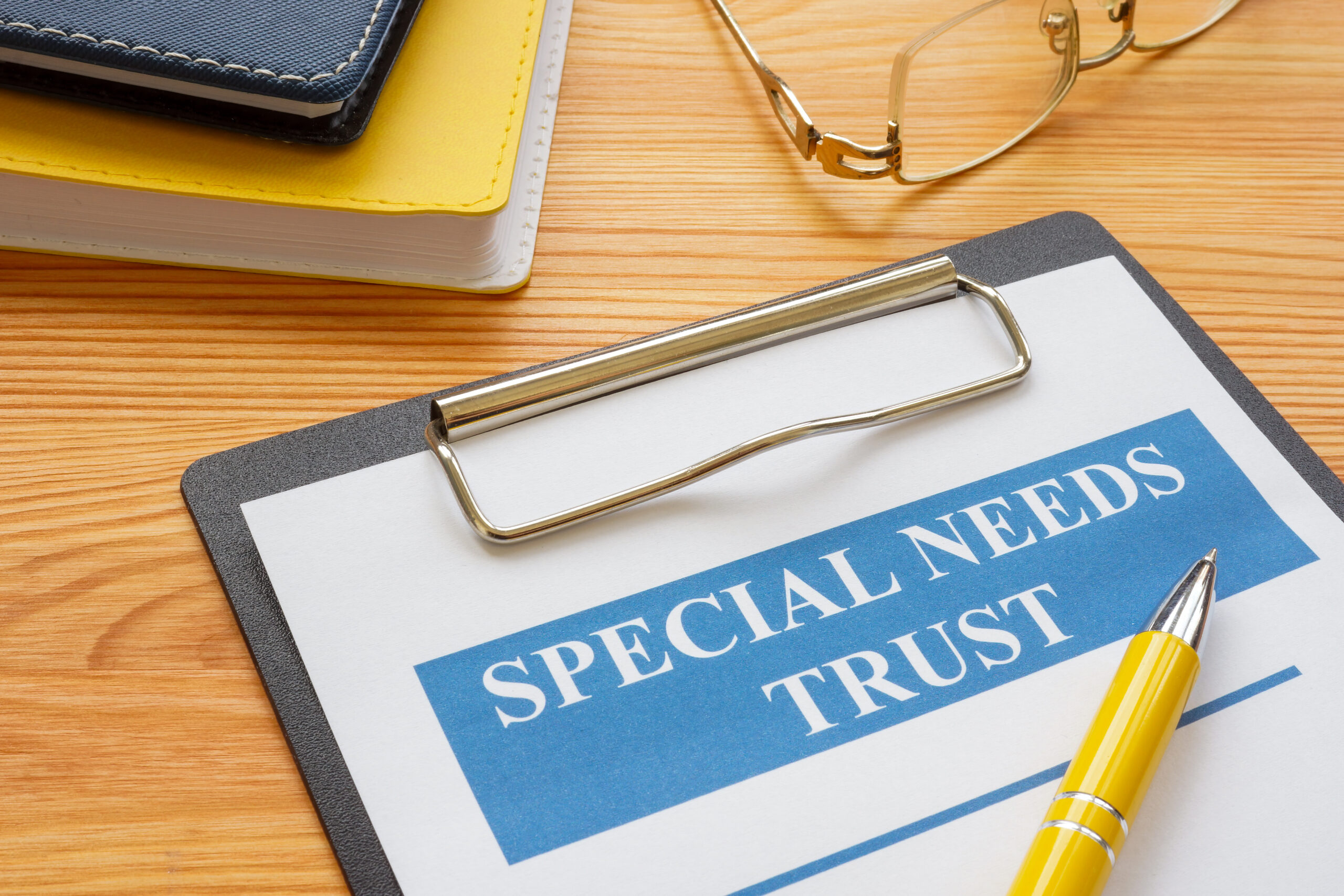 Special needs trust application with clipboard and notepad. Special needs trust application with clipboard and notepad.